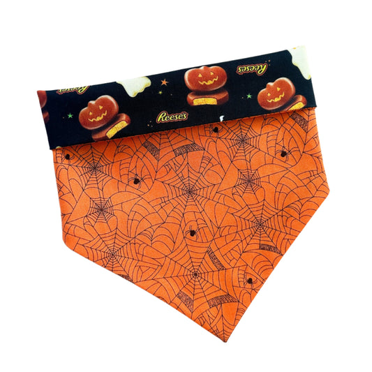 Halloween-themed dog bandana with orange pattern on a white background