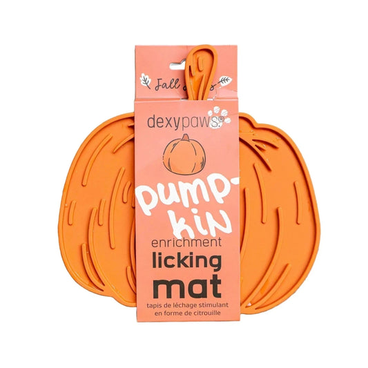 Orange pumpkin-shaped licking mat with pink packaging labeled 'dexypaws' on a white background